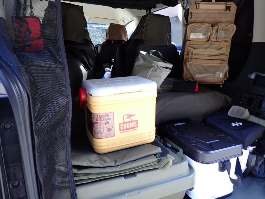 車の後部座席にCHUMSキャンパークーラー9Lを積んでいる様子